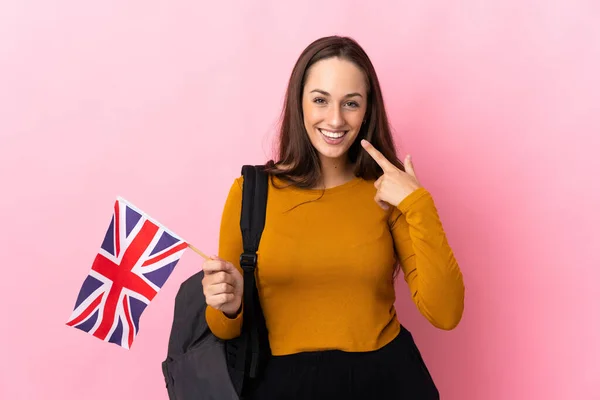 年轻的惊慌失措的女人举着英国国旗举起大拇指 — 图库照片