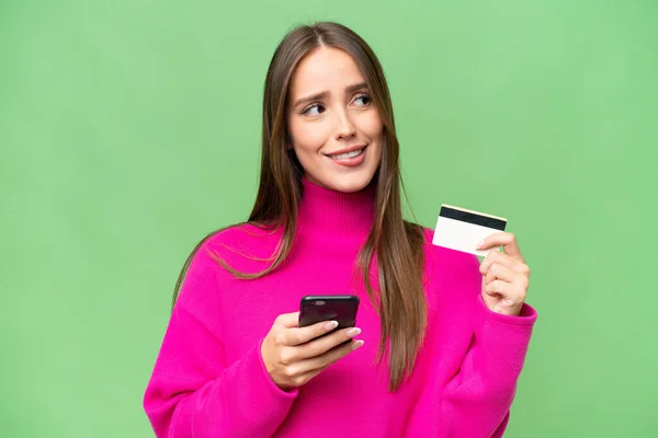 Young Beautiful Caucasian Woman Isolated Background Buying Mobile Credit Card — Stock Photo, Image
