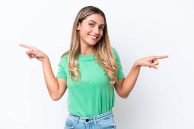 Young Uruguayan woman isolated on white background pointing finger to the laterals and happy