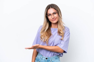 Young Uruguayan woman isolated on white background presenting an idea while looking smiling towards