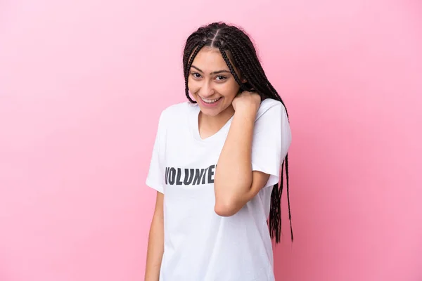 Stock image Teenager volunteer girl with braids isolated on pink background laughing