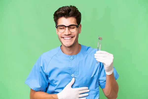 Young Dentist Man Holding Tools Isolated Background Smiling Lot — Stock Photo, Image