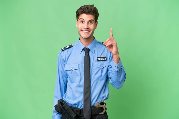 Jonge Politieman Geïsoleerde Achtergrond Wijzen Met Wijsvinger Een Geweldig Idee — Stockfoto