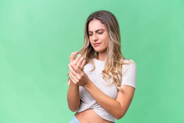 stock image Young Uruguayan woman over isolated background suffering from pain in hands