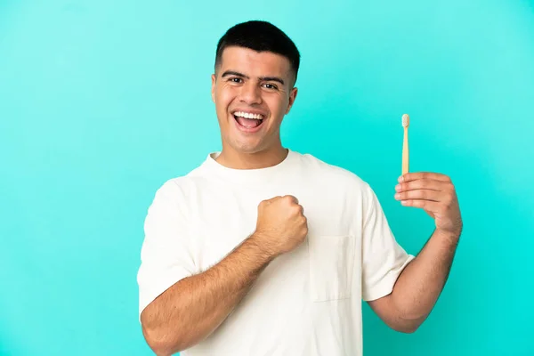 Young Handsome Man Brushing Teeth Isolated Blue Background Celebrating Victory — Fotografia de Stock