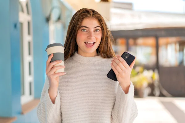 Giovane Donna Abbastanza Caucasica Utilizzando Telefono Cellulare Tenendo Caffè Con — Foto Stock