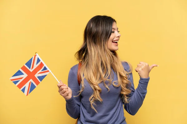 Young Russian Girl Holding United Kingdom Flag Isolated Yellow Background — Stock Photo, Image