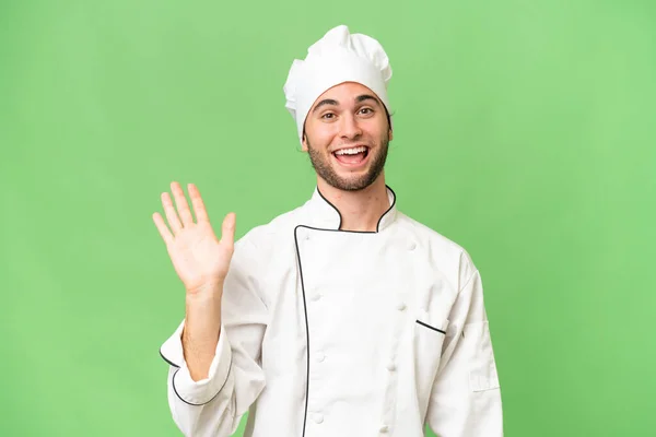 Jonge Knappe Chef Kok Geïsoleerde Achtergrond Salueren Met Hand Met — Stockfoto