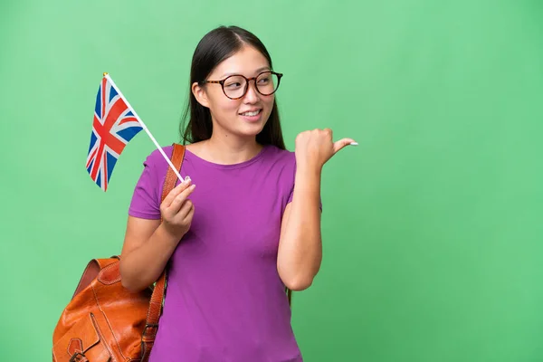 Young Asian Woman Holding United Kingdom Flag Isolated Background Pointing — Stockfoto