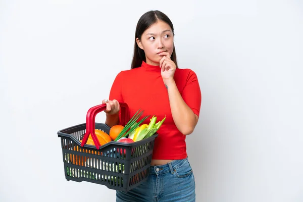 Young Asian Woman Holding Shopping Basket Full Food Isolated White — Stockfoto