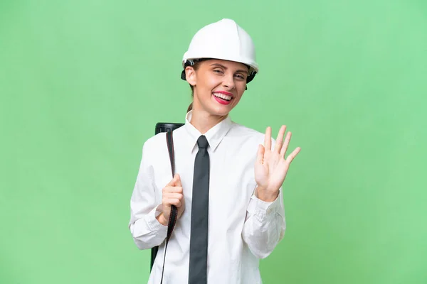 Young Architect Woman Helmet Holding Blueprints Isolated Background Saluting Hand — Stock Photo, Image