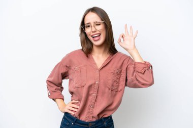 Young pretty caucasian woman isolated on white background showing ok sign with fingers