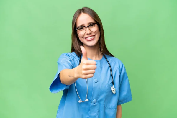 Young Nurse Caucasian Woman Isolated Background Thumbs Because Something Good — Stock Photo, Image