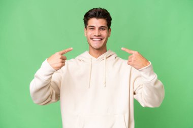 Young caucasian handsome man over isolated background giving a thumbs up gesture