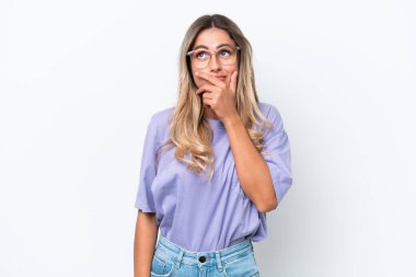 Genç Uruguaylı kadın beyaz arka planda izole edilmiş. Şüpheleri var ve kafası karışmış bir yüz ifadesi var.