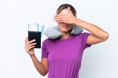 Şişirilebilir Seyahat Yastığı olan genç, güzel Uruguaylı bir kadın beyaz arka planda tek başına gözlerini kapatıyor. Bir şey görmek istemiyorum.