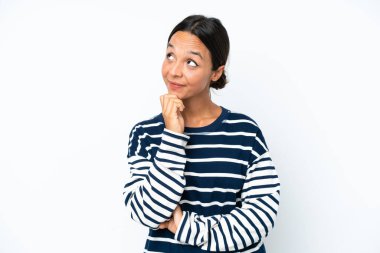 Young hispanic woman isolated on white background and looking up