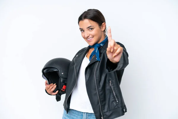 若いですCaucasian女性とともにオートバイヘルメット隔離上の青背景ショーと持ち上げる指 — ストック写真