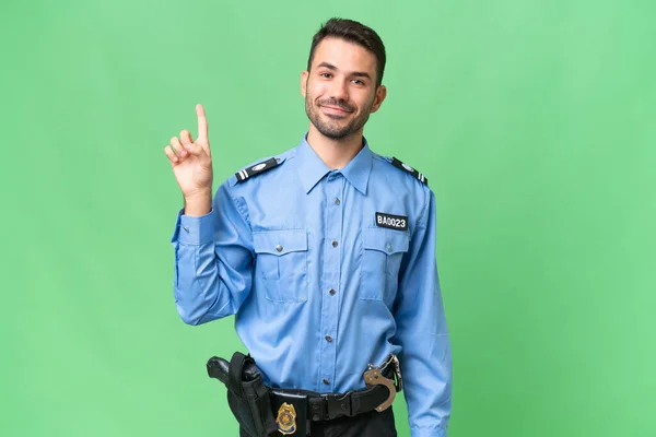 Junger Polizeikaukasier Mit Isoliertem Hintergrund Zeigt Und Hebt Einen Finger — Stockfoto