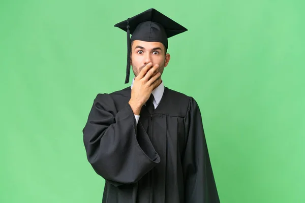 Jovem Universitário Graduado Homem Sobre Isolado Fundo Surpreso Chocado Olhar — Fotografia de Stock