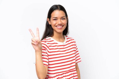 Young Colombian woman isolated on white background smiling and showing victory sign