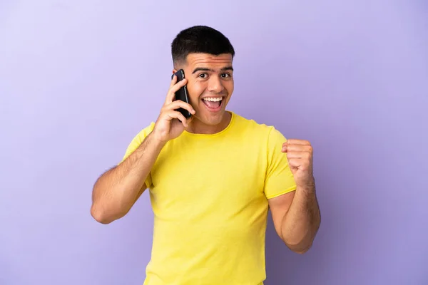 Joven Hombre Guapo Usando Teléfono Móvil Sobre Fondo Púrpura Aislado —  Fotos de Stock