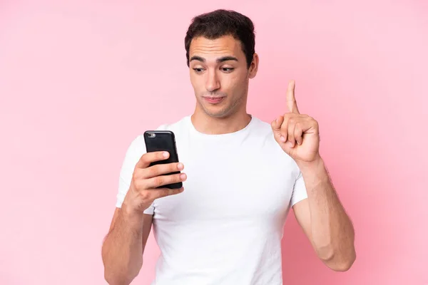 Jonge Blanke Man Geïsoleerd Roze Achtergrond Met Behulp Van Mobiele — Stockfoto