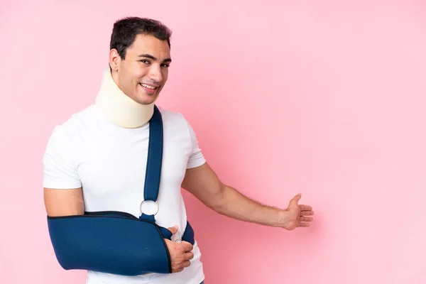 Young Caucasian Man Broken Arm Wearing Sling Isolated Pink Background —  Fotos de Stock