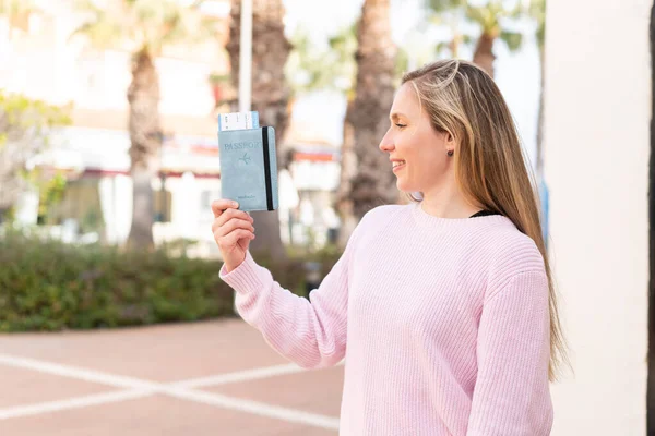 Młoda Blondynka Paszportem Świeżym Powietrzu Szczęśliwym Wyrazem Twarzy — Zdjęcie stockowe