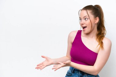 Young caucasian girl isolated on white background with surprise expression while looking side