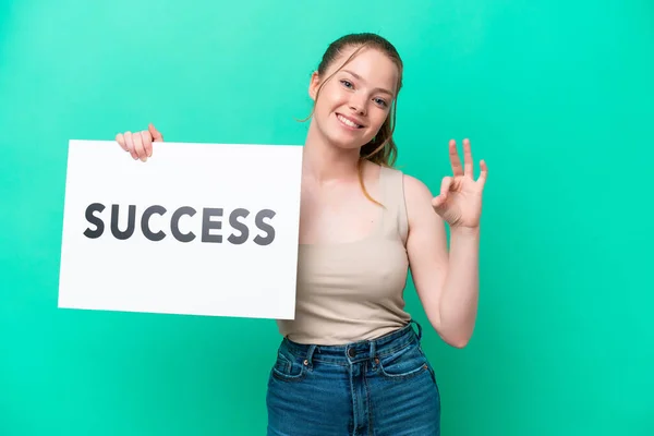 Young Caucasian Woman Isolated Green Background Holding Placard Text Success — Stockfoto