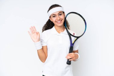 Young tennis player woman isolated on white background saluting with hand with happy expression