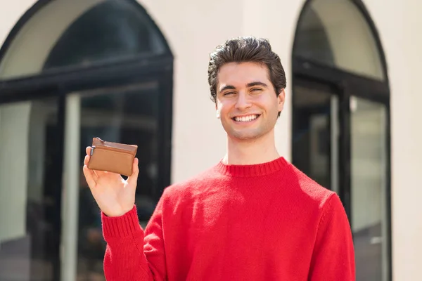 Young Handsome Man Holding Wallet Outdoors Smiling Lot — Stock Photo, Image