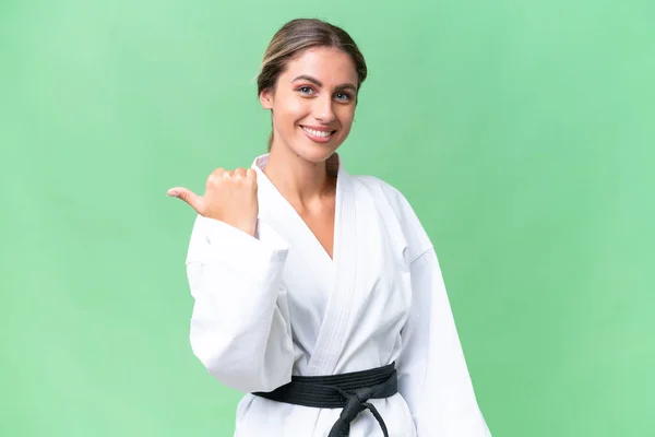 Young Uruguayan Woman Doing Karate Isolated Background Pointing Side Present — Stock Photo, Image