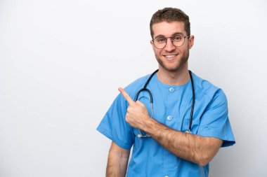 Young surgeon doctor caucasian man isolated on white background pointing to the side to present a product