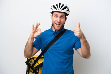 Young caucasian man with thermal backpack isolated on white background showing ok sign and thumb up gesture