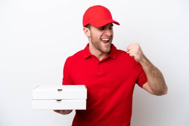 Pizza delivery caucasian man with work uniform picking up pizza boxes isolated on white background celebrating a victory