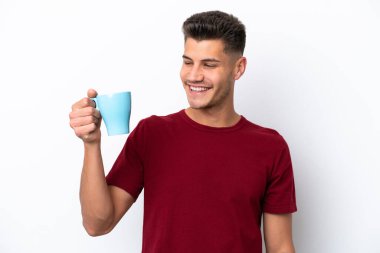 Young caucasian man holding cup of coffee isolated on white background with happy expression