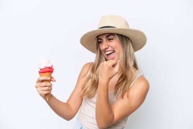 Young caucasian woman with a cornet ice cream isolated on white background celebrating a victory