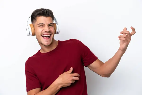 Jonge Blanke Man Geïsoleerd Witte Achtergrond Luisteren Muziek Doen Gitaar — Stockfoto