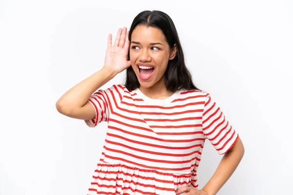 stock image Young Colombian woman isolated on white background listening to something by putting hand on the ear