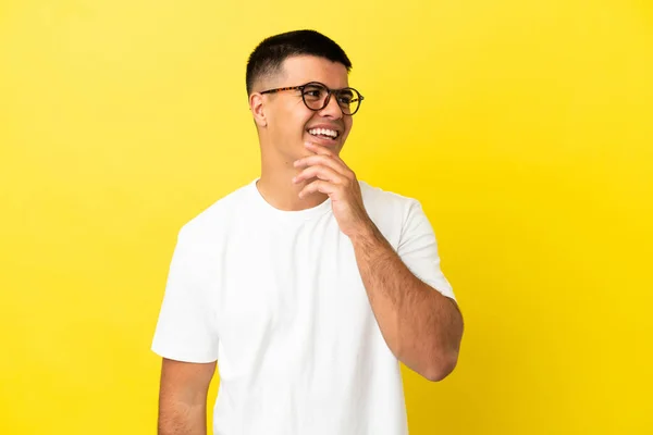 Young Handsome Man Isolated Yellow Background Looking While Smiling — Stock Photo, Image