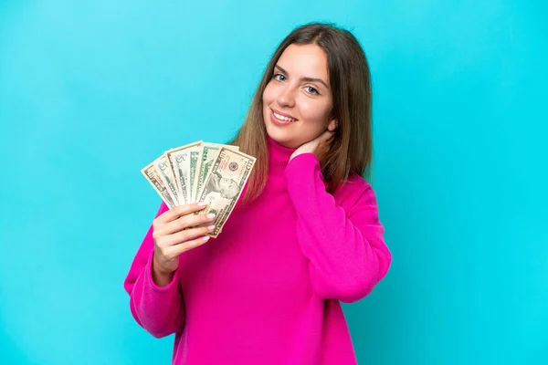 Young Caucasian Woman Taking Lot Money Isolated Blue Background Laughing — Stok fotoğraf