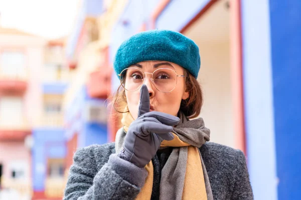Stock image Brunette woman at outdoors With glasses and doing silence gesture