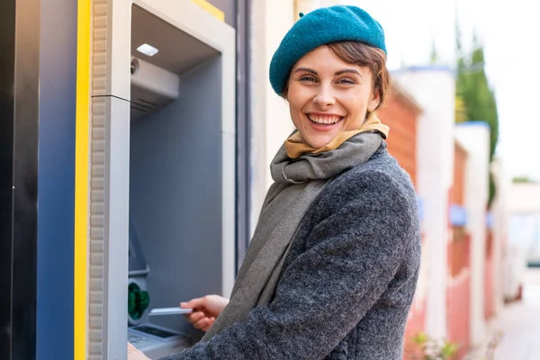 stock image Brunette woman holding a credit card at outdoors