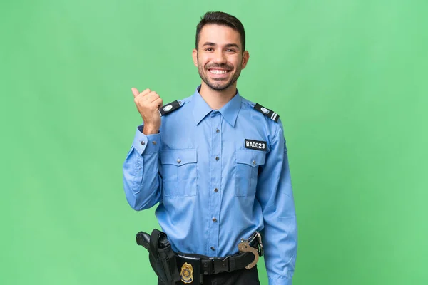 Молодий Поліцейський Білий Чоловік Над Ізольованим Тлом Вказує Бік Щоб — стокове фото