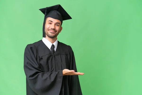 Young University Graduate Man Isolated Background Presenting Idea While Looking — Stock Photo, Image