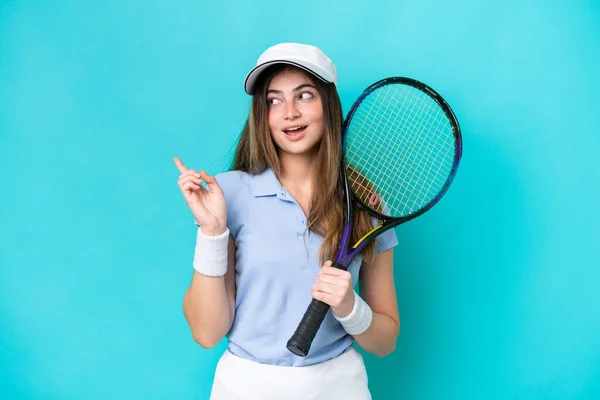年轻的网球选手被蓝色背景隔离 想在举手表决的同时实现这个解决方案 — 图库照片