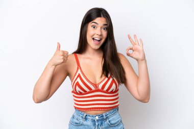 Young Brazilian woman isolated on white background showing ok sign and thumb up gesture