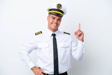 Beyaz arka planda izole edilmiş beyaz bir uçak pilotu en iyinin işareti olarak parmağını kaldırıyor.
